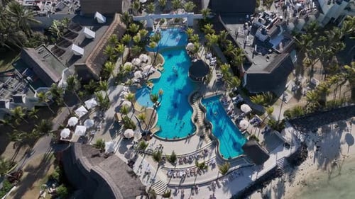 Top Down View Of The Resort Pool With Sun Beds On The Coast