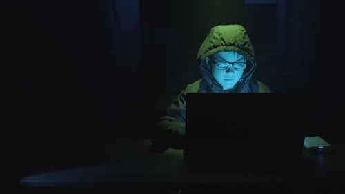 Young Boy Security Hacker Typing On A Laptop Computer At Night. - static