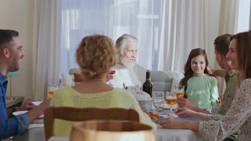 Waist Up Portrait View of the Multi Generation Family Sitting at the Dining Table During Festive
