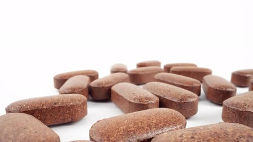 Close Up of Brown Multivitamin Supplements on White
