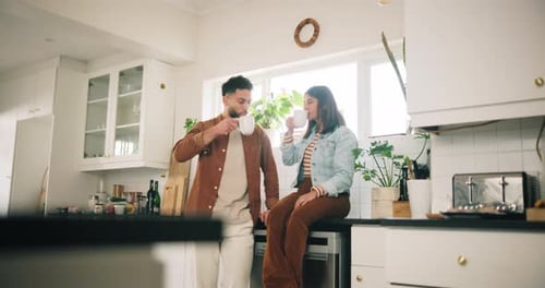 Couple Chatting Over Coffee in Modern Kitchen