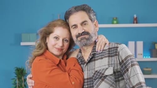 Middle age couple looking at camera.