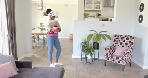 Young Adult Using Virtual Reality Headset in Living Room