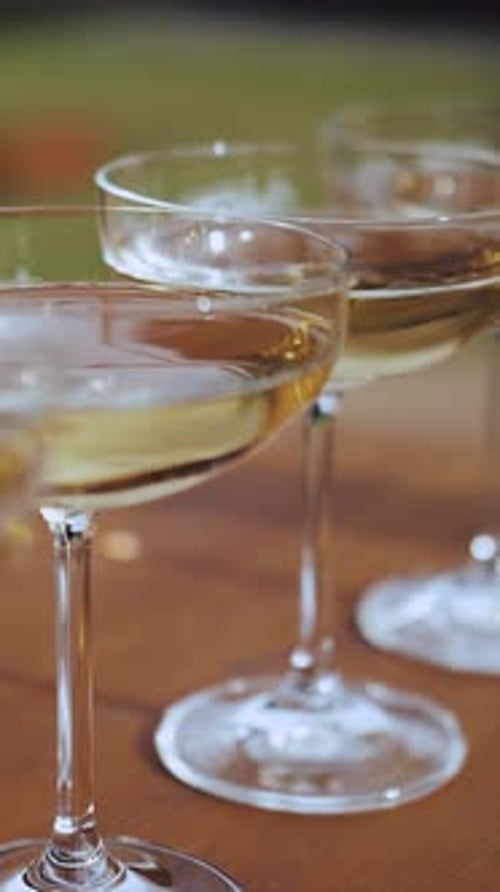 Glasses Filled with Champagne Wine in Glasses for a Holiday Catering Serving a Buffet with Champagne