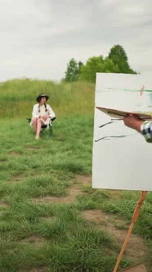 Artist Painting a Woman in Rural Grassy Setting