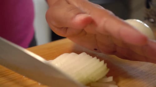 Adult Dicing White Onion on Cutting Board