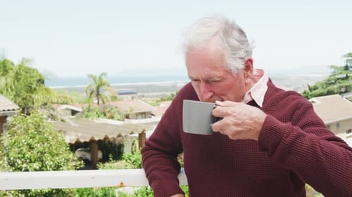 Senior Man Drinking Coffee on Porch Relaxing