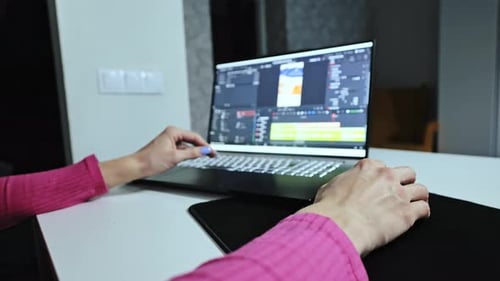 Adult Working at Laptop Editing Video