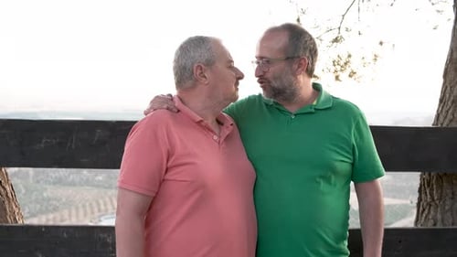 Adult Couple Embrace and Kiss in Nature