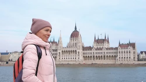 Woman By River on Budapest Parliament