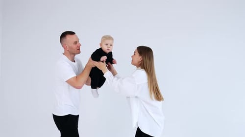 Loving Family Poses with Adorable Baby in Studio