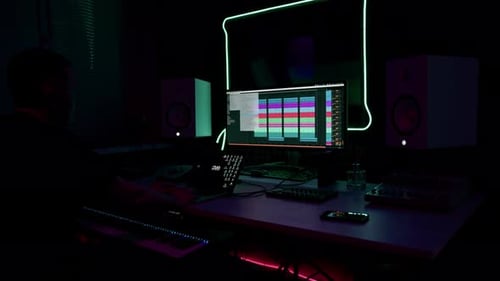 professional sound recording studio sound engineer or music producer sitting at the remote control