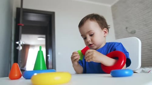 Cute Boy Playing with Educational Toys Indoors