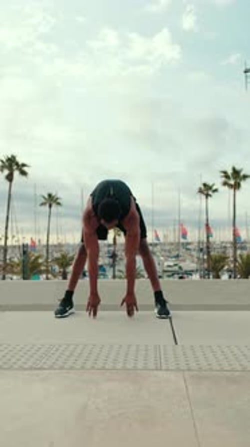 Vertical video, Young Fit Black Man Stretches by Marina