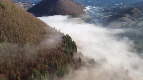 Aerial View of a Mountain Village in the Carpathians Morning Fog Covers Houses Fields and Forests in