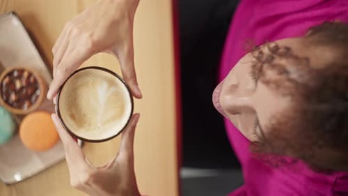 Top View of Beautiful African American Woman Drinking Coffee in Cafe