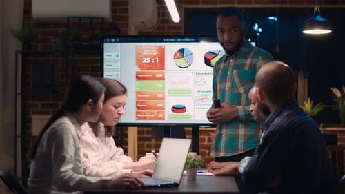 Team Analyzes Business Data Late in the Office