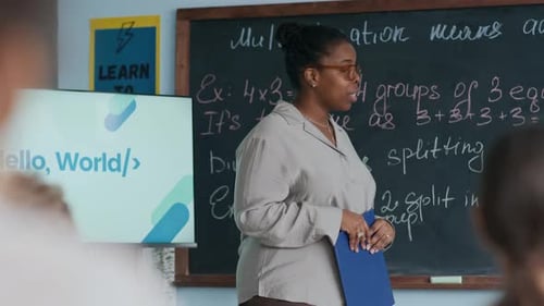 Enthusiastic Teacher Explaining Math Lesson to Students