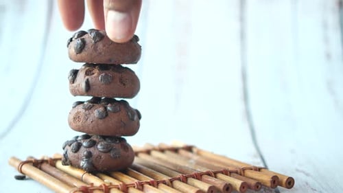 Stacked Chocolate Chip Cookies on Bamboo Platform
