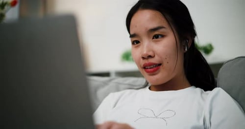 Young Woman Using Laptop at Home