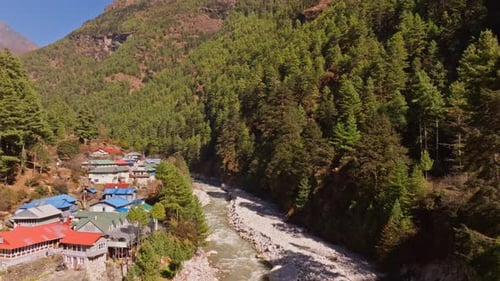 Aerial View of Turbulent Mountain River Winding Through Verdant Valley Near Jorsale Nestled Amid
