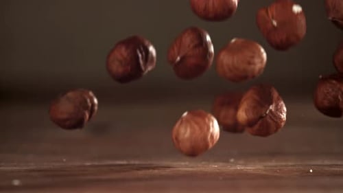 Falling Hazelnuts Slow Motion on Wooden Table