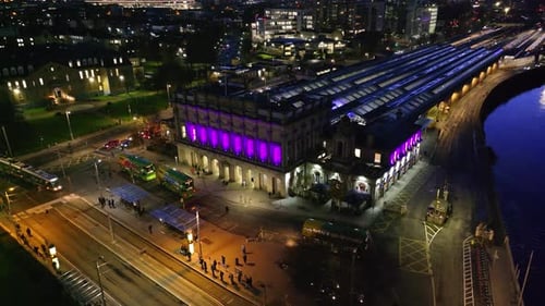 cinematic drone footage of Heuston Station in Dublin at sunset, highlighting the historic building,