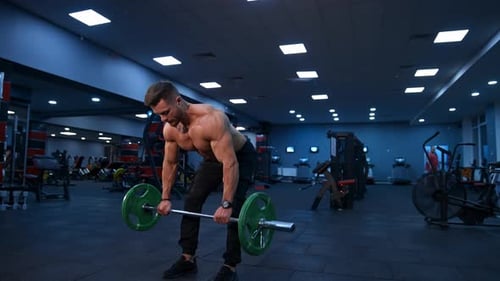 Fit young man lifting barbells doing workout at a gym. Sport, fitness, weightlifting, bodybuilding,