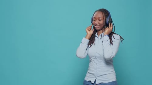Woman Listening to Music with Headphones and Dancing