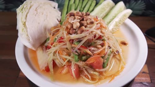 Authentic Thai Cuisine, Somtam, papaya salad with Sweet and Sour Sauce Freshly Made on a White Spinn
