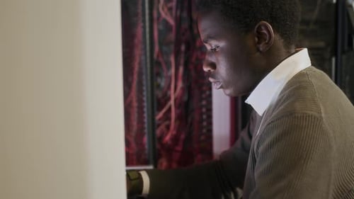 Adult Working by Data Servers in Room