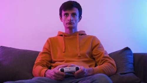 Man Playing Video Game on Couch