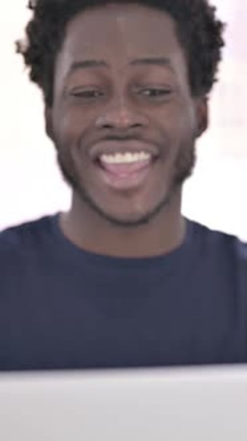 Close up of African Man doing Video Chat on Laptop, vertical video