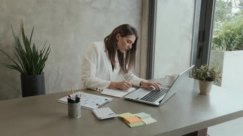 Woman Typing at Desk in Modern Workplace