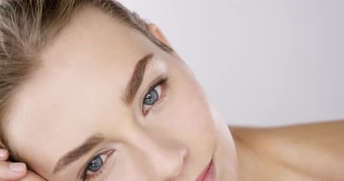 4k video footage of an alluring beautiful woman posing against a studio background