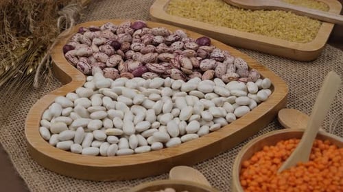 Colorful Dried Legumes and Grains in Wooden Bowls