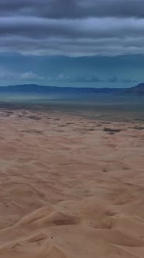 Sand dunes with storm clouds in Gobi Desert