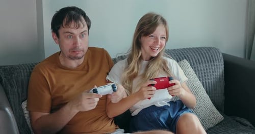 Excited Couple Plays Video Games at Home