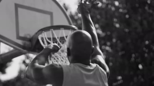 Basketball Player Shoots and Scores Action