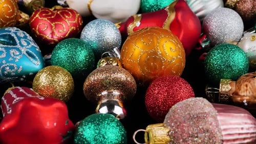 Bright Christmas ornaments close-up. Festive holiday background. Sparkling seasonal decoration.