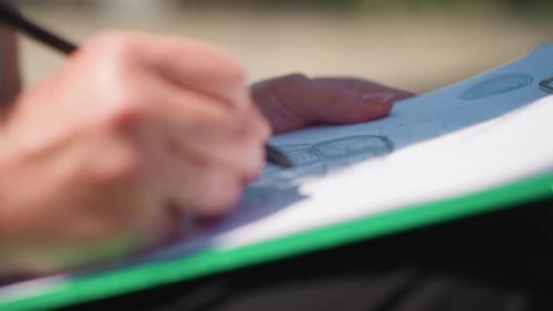 Artist Hand Sketching Car Drawing on Paper Outdoors