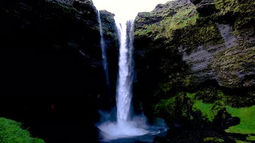 Waterfall in Iceland with Mossy Green Rock Faces