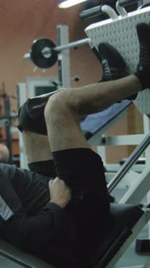 Man Using Leg Press With Prosthetic Leg in Gym