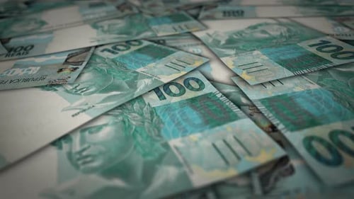 Brazil Real 100 banknote flying over money surface