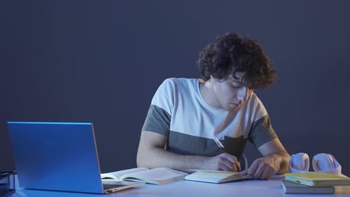 Male student studying at night.