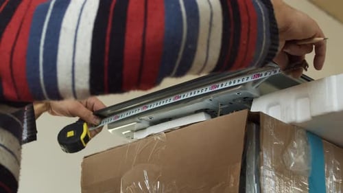 Worker Measuring Gas Cooktop Before Kitchen Installation