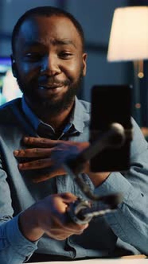 Man Vlogging with Smartphone on Gimbal at Night