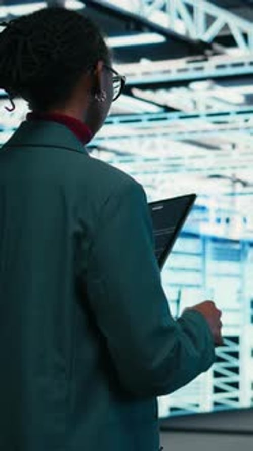 Vertical Video Writing Code Tablet and Female Programmer Walking in Data Center