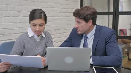 Business Team Discussing Documents in Modern Office