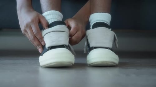 Close up of a man putting his shoes on before workout